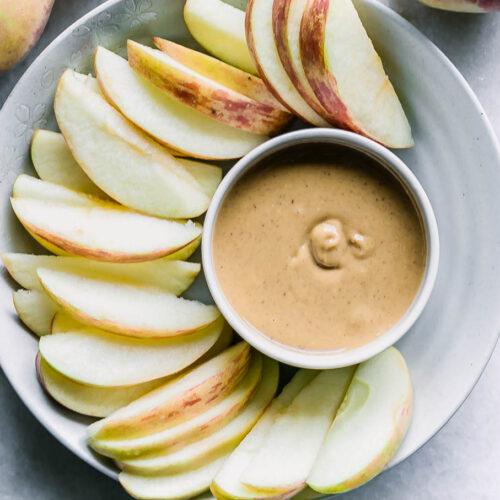 A Sweet Treat: Apple Slices with Peanut Butter and Granola.