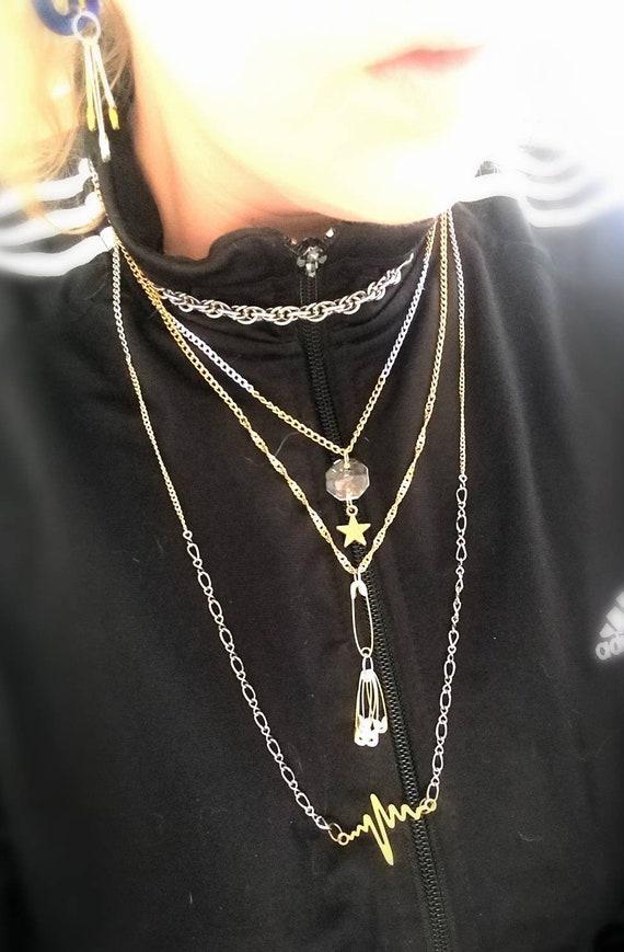 3) Modern Edge: Shift gears by incorporating chunky chains and statement links into your ensemble. Layer mismatched sizes and finishes for an eye-catching effect that exudes confidence. This trend works beautifully with graphic tees or tailored blazers, striking a perfect balance between edgy and chic